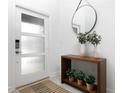 Bright and airy entryway with modern console table and round mirror at 4241 Paragraph Dr, Kissimmee, FL 34746