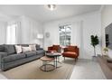 Relaxing living room with gray sofa and orange accent chairs at 4241 Paragraph Dr, Kissimmee, FL 34746