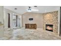 Spacious living room with stone fireplace and tiled floors at 45 Sackett Rd, Debary, FL 32713
