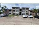 Two-story building exterior with ample parking at 4601 Cason Cove Dr # 214, Orlando, FL 32811