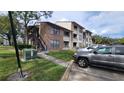 Side view of condo building with stairs and parking at 4601 Cason Cove Dr # 214, Orlando, FL 32811