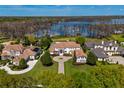 Luxury estate home on a lake with beautifully landscaped grounds and neighboring homes at 9343 Tibet Pointe Cir, Windermere, FL 34786