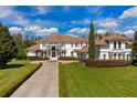 Impressive two-story home with a long driveway and lush landscaping at 9343 Tibet Pointe Cir, Windermere, FL 34786