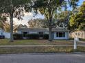 Charming single-story home with a well-maintained front yard and mature trees at 1216 Sand Pine Ave, Ocoee, FL 34761