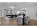 Open concept dining area with hardwood floors and modern chandelier at 14279 Crest Palm Ave, Windermere, FL 34786