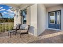 Covered porch with seating area and brick pavers at 14279 Crest Palm Ave, Windermere, FL 34786