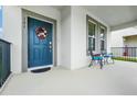 Covered front porch with blue door and metal railings at 151 Wooded Vine Dr, Winter Springs, FL 32708