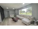 Living room boasts a comfy sectional sofa, large window, and modern coffee table at 1625 Normandy Way, Leesburg, FL 34748