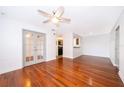 Bright living room with polished wood floors, ceiling fan, and French doors at 2007 Dixie Belle Dr # 2007A, Orlando, FL 32812