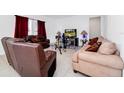 Living room with brown leather couches and a glass coffee table at 2362 Lancashire St, Davenport, FL 33896
