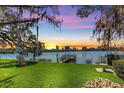 Lakefront backyard with a dock, offering stunning sunset views and a serene atmosphere at 320 Lakeview St # 123, Orlando, FL 32804
