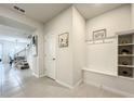 Light and bright entryway with built-in bench seating and shelving at 4190 Lana Ave, Davenport, FL 33897