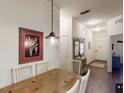 Dining area with wooden table, white chairs, and entryway with mirror and console table at 605 Rum Run # 605, Davenport, FL 33837