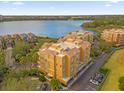 Drone view of a residential building complex, showcasing its location near a lake at 7500 Toscana Blvd # 333, Orlando, FL 32819