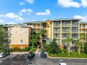 Aerial perspective of the condo building, highlighting its architecture, balconies, and surrounding greenery at 9051 Treasure Trove Ln # 102, Kissimmee, FL 34747