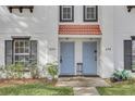 Close-up of two light blue front doors of a townhouse, framed by white walls and black shutters at 234 N Glenwood Ave # 4, Orlando, FL 32803