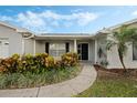 Close-up of the front entrance with lush landscaping and a covered porch at 4373 Wyndcliff Cir, Orlando, FL 32817