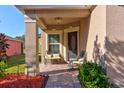 Covered front porch with seating, decorative columns, and a charming entryway at 5818 Great Egret Dr, Sanford, FL 32773