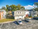 Aerial view of a condo building with parking and lush landscaping at 7309 Daniel Webster Dr # O-3A, Winter Park, FL 32792