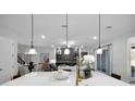 Modern kitchen island with white quartz countertop and pendant lighting at 14268 Crest Palm Ave, Windermere, FL 34786