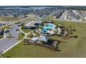 Community pool, playground, and clubhouse surrounded by homes and green space at 2075 Heart Lake Dr, Groveland, FL 34736