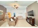 Spacious living room featuring a comfortable couch and large TV at 2464 Deer Creek Blvd, St Cloud, FL 34772