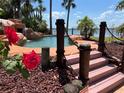 Relaxing pool with a waterfall and steps leading to the water at 2904 S Peninsula Dr, Daytona Beach Shores, FL 32118