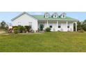 Close-up view of farmhouse exterior with green metal roof and charming front porch at 3520 Hyder Ave, Deltona, FL 32738