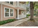 Inviting front porch with white railings, double windows, and lush landscaping at 502 Water St, Celebration, FL 34747