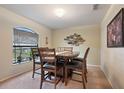Dining room with arched window, wooden table, and carpeted floors at 5761 Woodruff Way, Lakeland, FL 33812