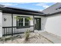 Inviting front porch with black railings and hanging planters at 614 White River Dr, Orlando, FL 32828