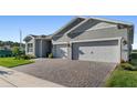 Welcoming home exterior with a large driveway and front lawn at 6535 Shimmering Shores Ln, St Cloud, FL 34771