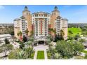 View of a grand resort-style building with lush landscaping at 7632 Excitement Dr, Reunion, FL 34747