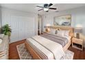 Inviting bedroom with wooden platform bed, white closet, nightstands, and patterned rug at 148 Harwood Cir, Kissimmee, FL 34744