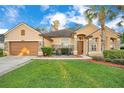 One-story house with a welcoming front porch and lush lawn at 1942 Willow Wood Dr, Kissimmee, FL 34746