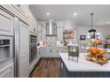 Spacious kitchen featuring white shaker cabinets, stainless steel appliances, and a patterned backsplash at 25459 Hawks Run Ln, Sorrento, FL 32776