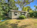 Charming single-story home with green trim and a spacious front yard at 3109 Williams St, Orlando, FL 32806