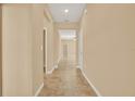 Light and bright hallway with tile flooring at 440 Alcove Dr, Groveland, FL 34736