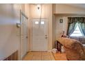 Front entry door with tile flooring and adjacent double doors at 6554 Meritmoor Cir, Orlando, FL 32818