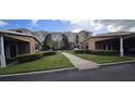 Community walkway leads to condo buildings with covered parking areas at 8252 Civita Dr # 201, Davenport, FL 33896