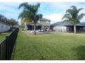 Fenced backyard with a pool, screened patio, and lush lawn at 915 Ekana Green Ct, Oviedo, FL 32765