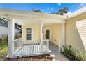 Front porch with white railing and entry door at 2436 Princeton Ave, Sanford, FL 32771