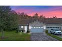 Attractive home at dusk with a paved driveway and landscaping at 2807 Plymouth Pl, Kissimmee, FL 34741