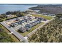 A high angle shot of a housing development near a lake and agricultural fields at 3007 Tackle Dr, Leesburg, FL 34748