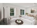 Living room with white sectional sofa, coffee table, and dining area at 3318 Thicket St, Tavares, FL 32778