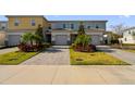 Row of townhouses with paved driveways and landscaping at 780 Driving Range Ct, Reunion, FL 34747