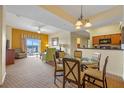 Bright dining area with a glass-top table and four chairs, adjacent to the kitchen at 8112 Poinciana Blvd # 1709, Orlando, FL 32821