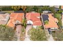 Aerial view of a house with a red tile roof among other houses at 11410 Rapallo Ln, Windermere, FL 34786
