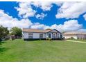 One-story home with green grass, an attached garage, and a driveway at 17 Trotters Cir, Kissimmee, FL 34743