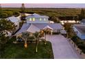 Modern coastal home with metal roof and landscaped yard near the water at 25 Cunningham Dr, New Smyrna Beach, FL 32168